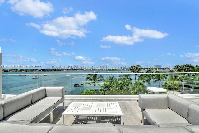 balcony with a water view and an outdoor hangout area