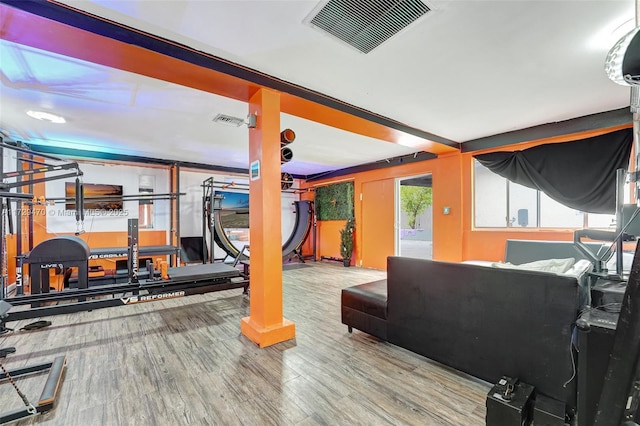 exercise room with hardwood / wood-style floors