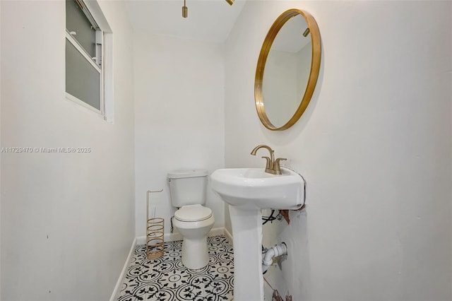 bathroom featuring tile patterned floors and toilet