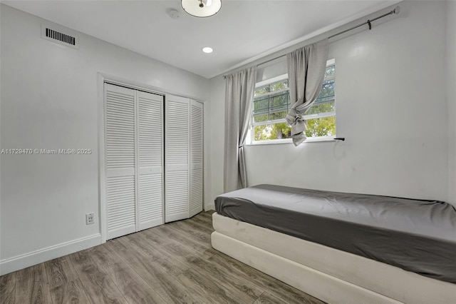 bedroom featuring a closet and light wood-type flooring