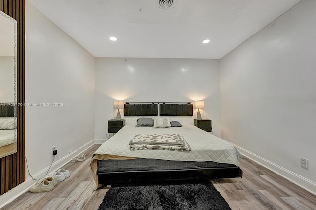 bedroom with hardwood / wood-style floors