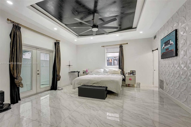 bedroom with ceiling fan, a raised ceiling, access to outside, and french doors