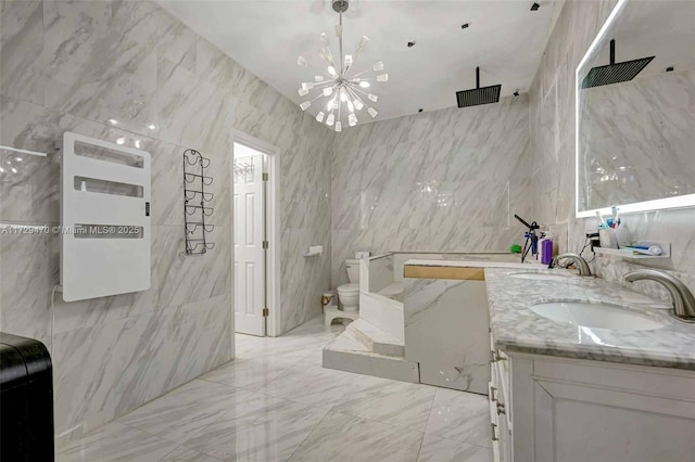 bathroom with tile walls, toilet, vanity, and walk in shower