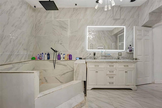 bathroom featuring a shower, tile walls, and vanity