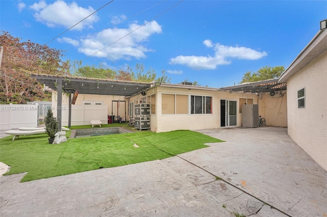 back of house with a patio area, a lawn, and a pergola