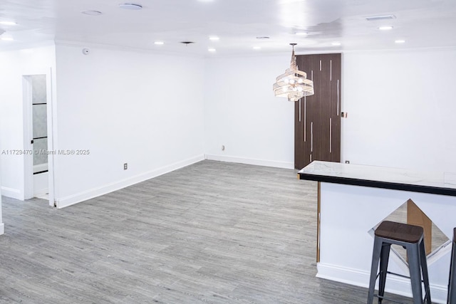 spare room featuring crown molding and light hardwood / wood-style floors