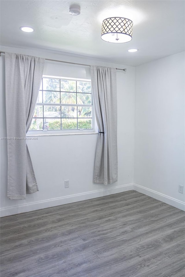 empty room featuring dark wood-type flooring