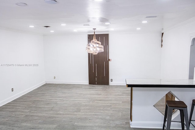 empty room with light hardwood / wood-style flooring and ornamental molding