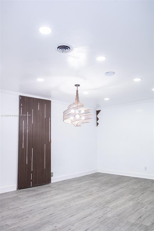 unfurnished room featuring ornamental molding and light hardwood / wood-style flooring