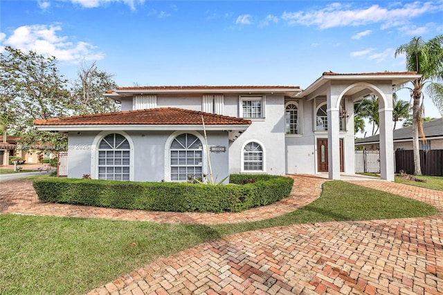 mediterranean / spanish house featuring a front yard