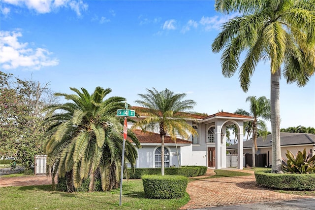 mediterranean / spanish-style house with a front lawn