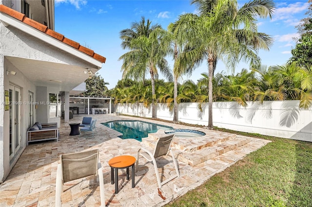 view of pool featuring an in ground hot tub, a patio area, and a water view