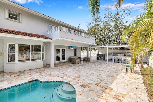 view of pool featuring a patio area and exterior bar