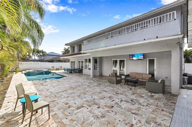 view of pool featuring an outdoor living space and a patio area