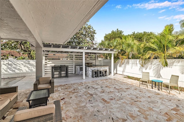 view of patio with exterior bar and an outdoor kitchen