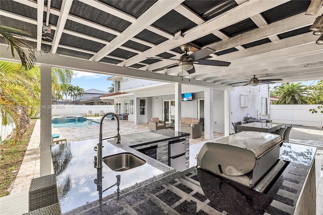 view of patio with exterior kitchen, a fenced in pool, ceiling fan, an outdoor living space, and a wet bar