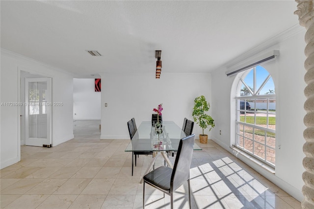 dining room featuring crown molding