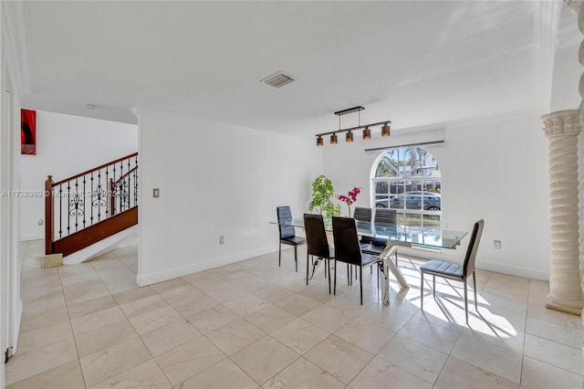 dining area with decorative columns, crown molding, and light tile patterned flooring