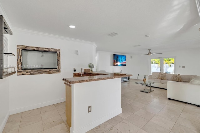 kitchen featuring ceiling fan and ornamental molding