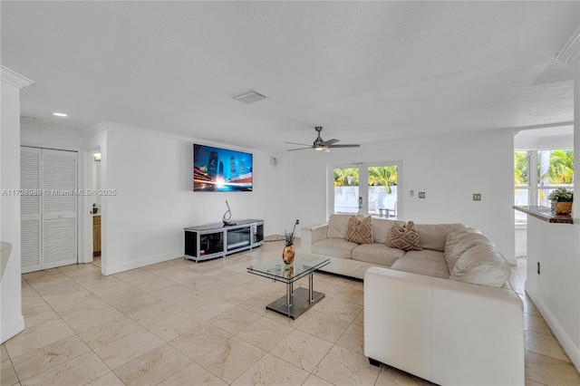 living room featuring ceiling fan, french doors, crown molding, and a textured ceiling