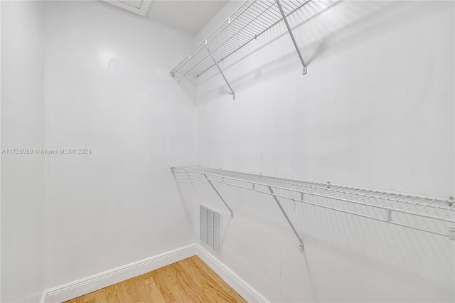 spacious closet featuring hardwood / wood-style flooring