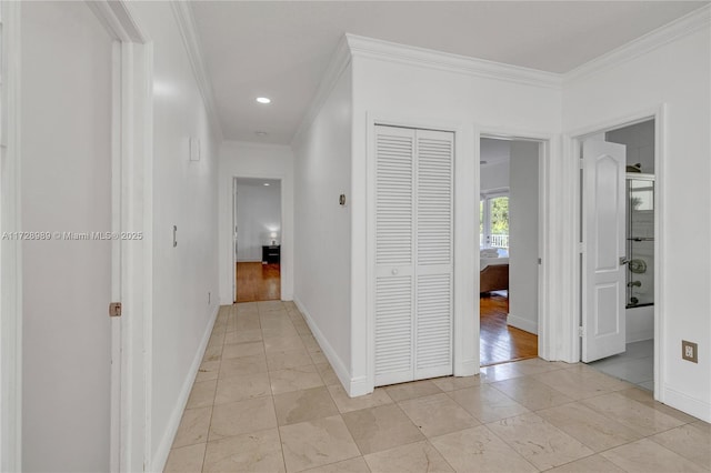 hall with ornamental molding and light tile patterned flooring