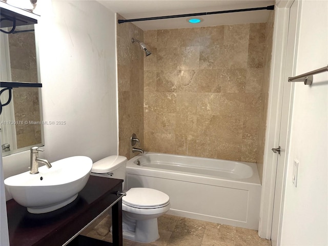 bathroom featuring toilet, vanity, and bathtub / shower combination