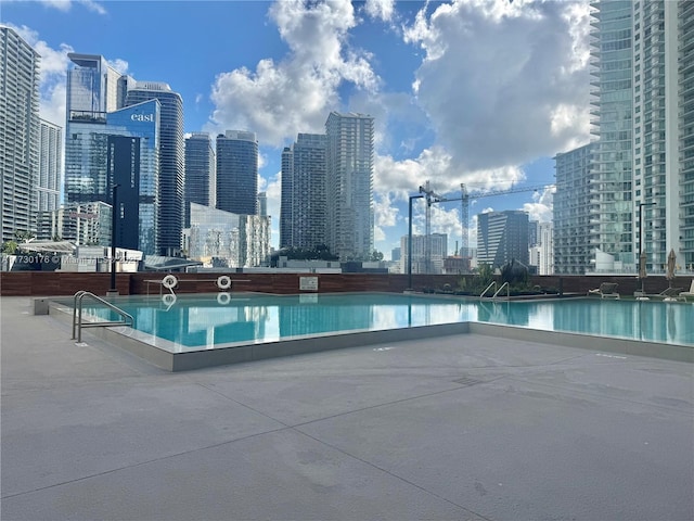 view of swimming pool featuring a view of city