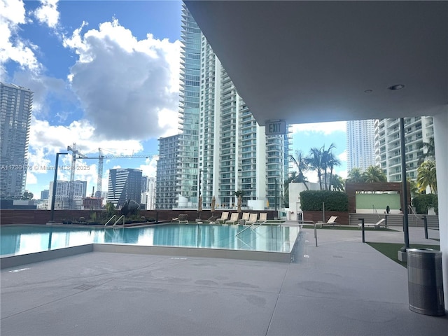 pool with a patio and a view of city
