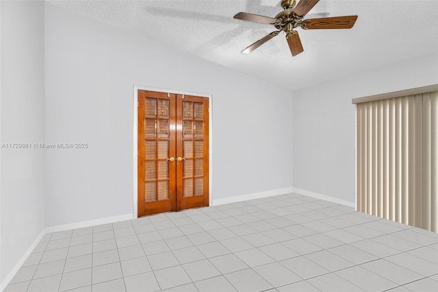 unfurnished room with ceiling fan, a textured ceiling, french doors, and light tile patterned flooring