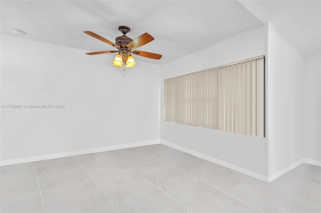 tiled spare room featuring ceiling fan