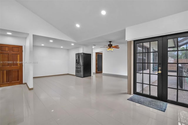 interior space featuring ceiling fan, light tile patterned floors, lofted ceiling, and french doors