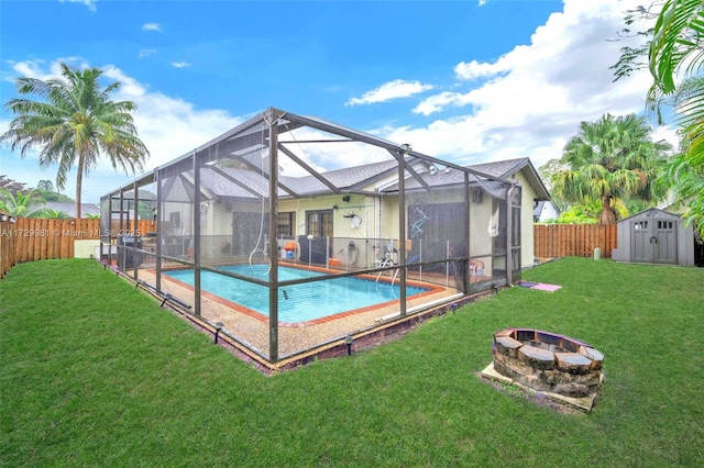 view of pool with an outdoor fire pit, a shed, a lawn, and a lanai