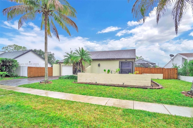 view of front of property with a front yard and a garage