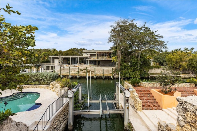 view of dock with a patio area and a water view