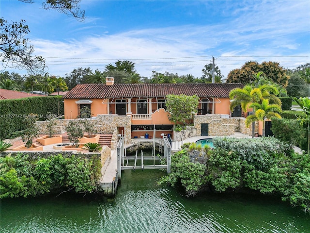 back of house featuring a water view