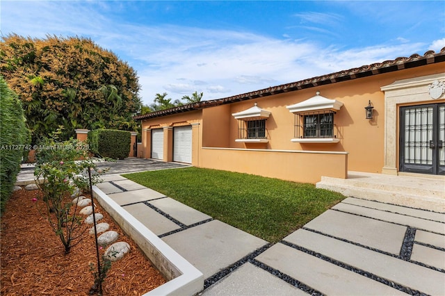 exterior space with a garage and a front yard