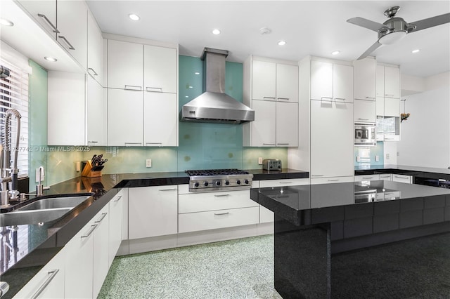 kitchen with sink, white cabinetry, appliances with stainless steel finishes, and extractor fan