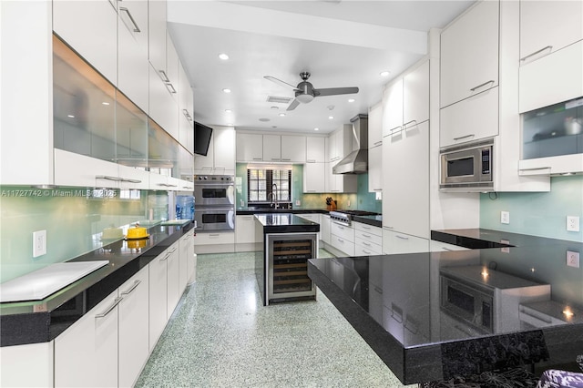 kitchen featuring wine cooler, a spacious island, white cabinets, stainless steel appliances, and wall chimney exhaust hood