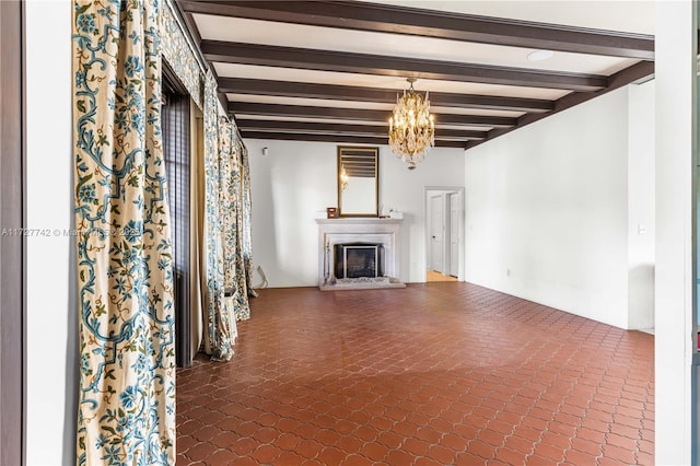 unfurnished living room featuring a notable chandelier and beam ceiling