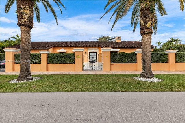 mediterranean / spanish house with a front yard