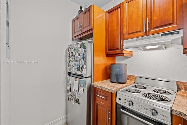 kitchen featuring range with electric cooktop and stainless steel refrigerator