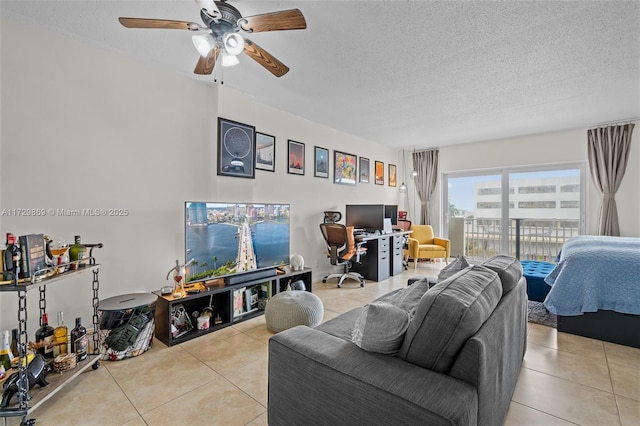 tiled living room featuring ceiling fan and a textured ceiling