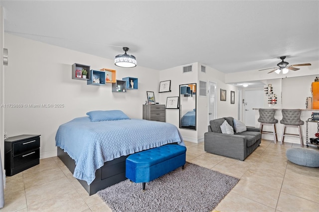 bedroom featuring ceiling fan, bar, and tile patterned flooring