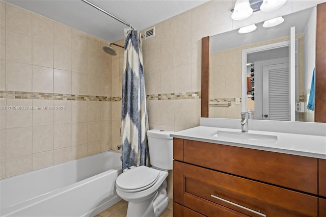 full bathroom featuring vanity, toilet, tile walls, and a textured ceiling