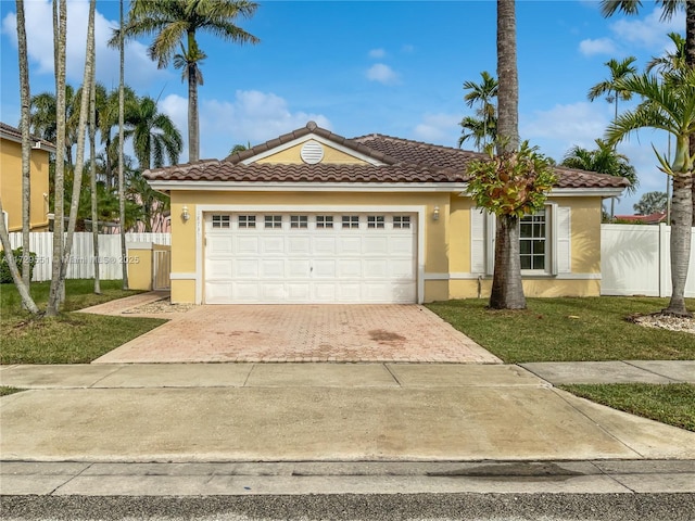 view of front of property featuring a garage and a front lawn