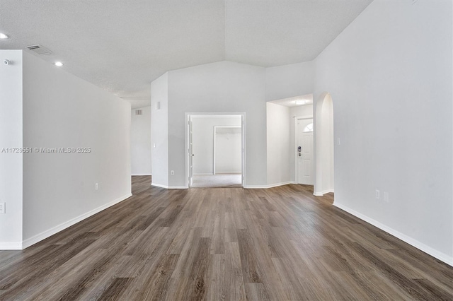 spare room with lofted ceiling and dark hardwood / wood-style floors