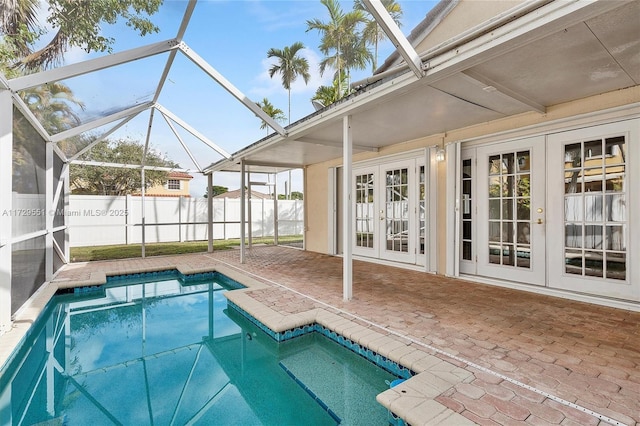 view of swimming pool featuring a patio area, french doors, and glass enclosure