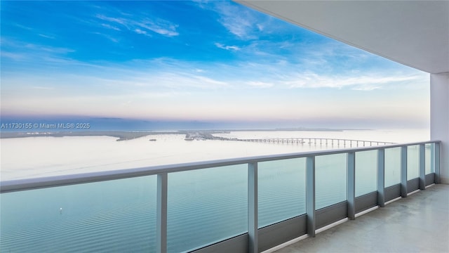 balcony featuring a water view and a beach view