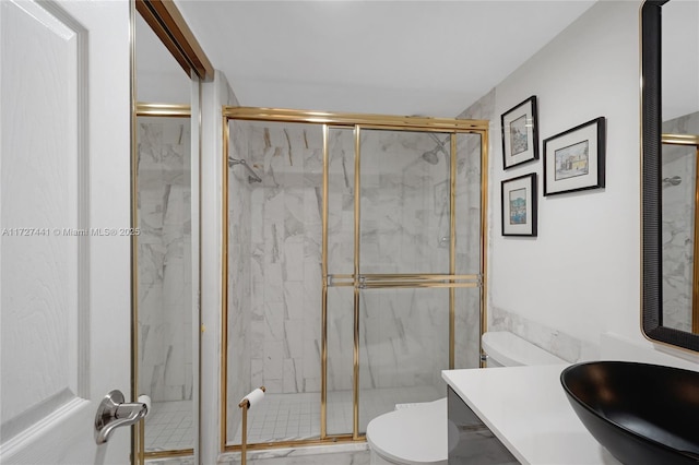 bathroom featuring sink, an enclosed shower, and toilet